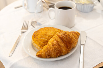 Breakfast in France with fresh baked butter, pain chocolate croissant or pain raisin or chausson aux pommes pastries in artisanal bakery in Paris, France, close up