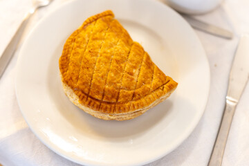 Breakfast in France, fresh baked chausson aux pommes, apple pastries in artisanal bakery in Paris, France, close up