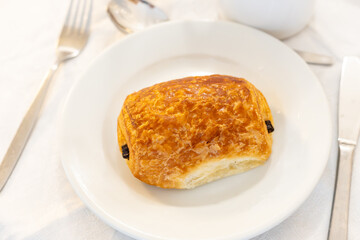 Breakfast in France, fresh baked butter chocolate croissant pastries in artisanal bakery in Paris, France, close up