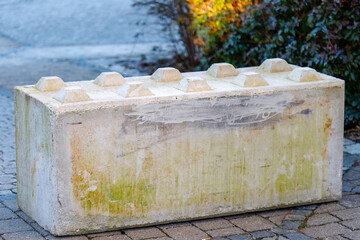 Concrete lego style barrier block on pavement © de-nue-pic