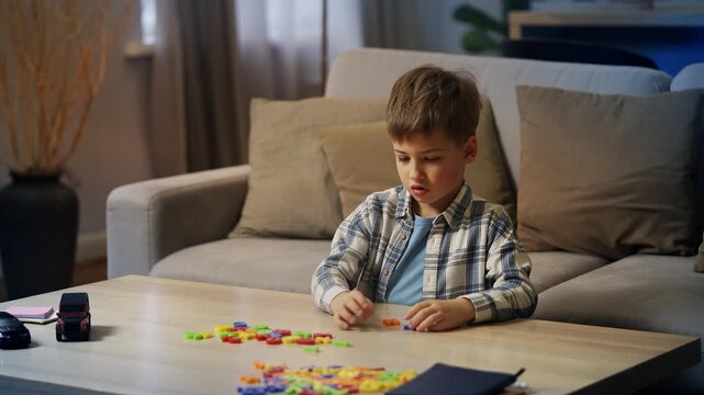 Cute little boy playing with colorful number toy set, learning basic mathematics