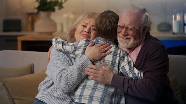 Excited little grandson embracing his grandparents, happy family relationships