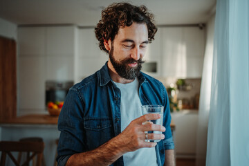 Man drinking fresh water for healthy hydration at home