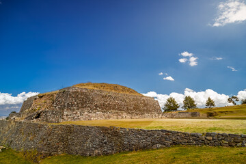Ancient Tlaloc temple pyramid ruins under bright sunny sky in Calixtlahuaca, Mexico