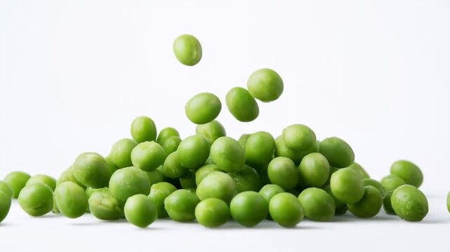 Fresh and tasty peas falling on white background
