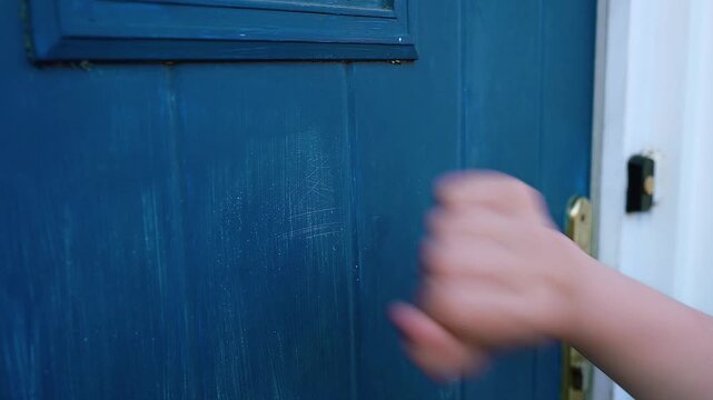 Close-up a child knocking on the door from the front of the house High quality FullHD footage