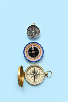 Different compasses on blue background