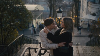 A romantic couple embraces in the Montmartre district of Paris France sharing an affectionate...