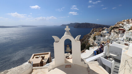 Panorama with white bell tower of Santorini Oia village