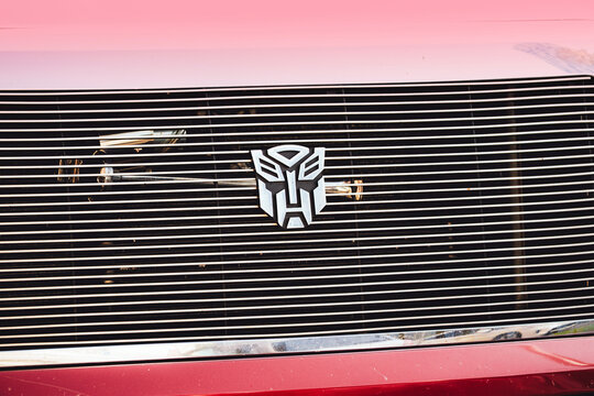 6 November 2025, Batumi, Georgia: Autobot like emblem mounted on a red vehicle's front grille, representing transformers and pop culture themes