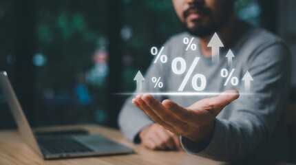 A man's open hand displays glowing percentage symbols with upward arrows illustrating financial growth A laptop rests on a wooden desk nearby with blurred city lights in the background