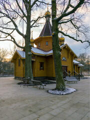 raditional Wooden Russian Orthodox Church at Sunset in Winter