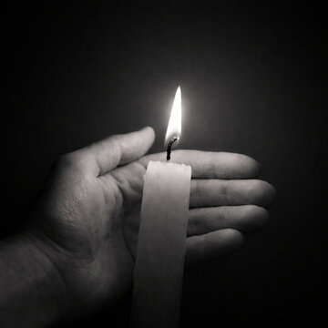 black and white, monochrome, candle, candle flame, burning candle, flame, wax, wick, glow, light, hand, human hand, holding candle, centered composition, symmetry, minimal, minimalist, copy space