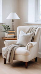 Fototapeta premium Cozy bedroom reading nook with chair, throw blanket, and lamp for relaxation