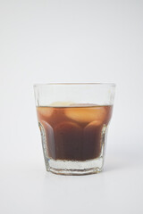 Refreshing glass of iced coffee or cold brew tea with ice cubes