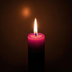 A single red candle burning brightly in the darkness.