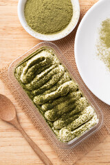 Matcha Tiramisu cake with green tea powder on top, Italian dessert fusion with Japanese, Top view