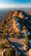 Winding Road Through Rocky Mountains Under Clear Blue Sky in Remotely Located Nature Area