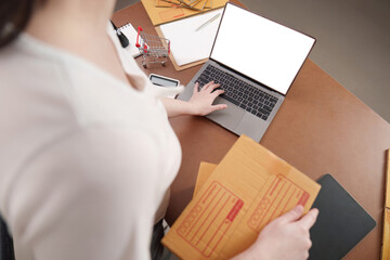 Organizing packages and managing tasks at a laptop