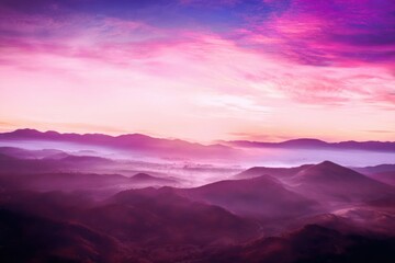 Endless layers of purple mountains and valleys bathed in soft pink and purple sunrise light range