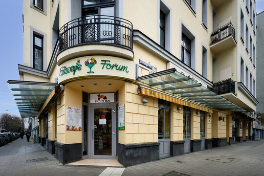 Cologne, Germany December 17 2025: Eiscafe Forum Ice Cream Parlor in Cologne Suedstadt, Classic architecture with a curved balcony, glass awnings, and sidewalk view