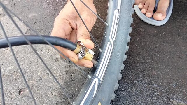 Filling air in bicycle wheels at the gas station.