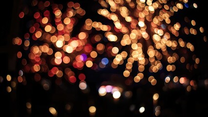 Abstract bokeh lights creating a festive and magical atmosphere on a dark background, blurred circles of illumination for celebration.