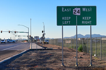 Directional highway signage for the Gateway Freeway - Arizona State Route 24 showing east and west lanes, illustrating roadway navigation, traffic control, and regional transportation infrastructure