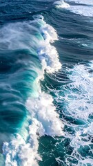 Crashing blue waves crest and foam, churning the ocean's surface in a dynamic display of natural power