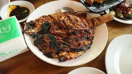 Grilled fish is a traditional Indonesian dish. Some dishes are served with spicy seasonings or...