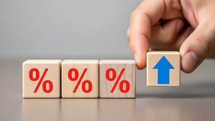 Hand placing a wooden block with an upward arrow next to three blocks with percentage symbols, signifying a rate increase.