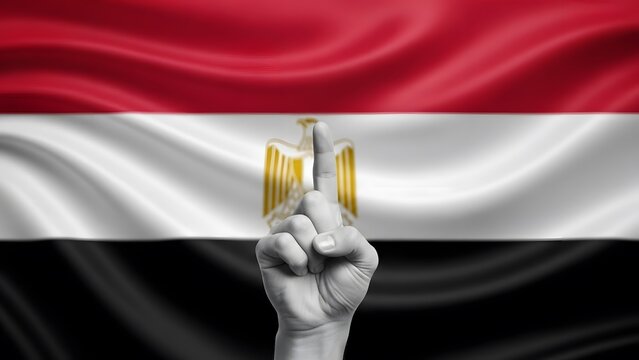 A grayscale hand with an index finger pointing up, superimposed with the Egyptian eagle, against a waving Egyptian flag.