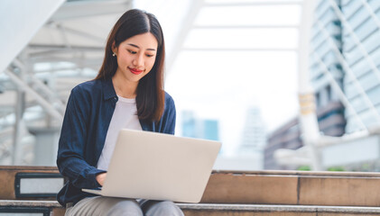 Asian business woman using laptop device remote work with fast wireless internet and ai modern technology