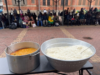 Community Food Distribution with Rice and Stew at Outdoor Feeding Station