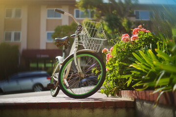 LOS ANGELES, CA - April 7, 2025: Beach cruiser bicycle bike parked on sunny city street. 