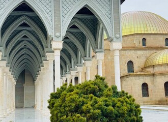 White arch with classical columns inside Rabati Castle, Georgia, contrasting with medieval stone walls and symbolizing the blend of historical architecture and modern restoration