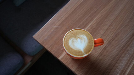 A cup of hot latte coffee on the table for breakfast