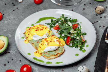 Sandwiches with avocado and poached egg, healthy breakfast.