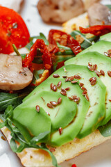 Baguette with guacamole, champignons mushrooms and micro green on white plate. Brunch ideas. Vegan protein source. healthy food. clean eating.
