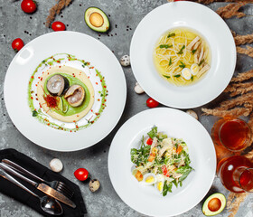 Business lunch set made of three meals. Large lunch set of three courses soup, second course and salad. Caesar salad, Ukrainian borscht and hash brown with mushrooms in a creamy sauce.