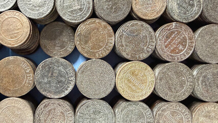 A close-up view of various Russian Empire coins stacked together, showcasing their different textures and colors