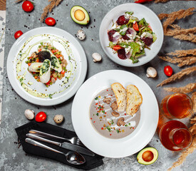 Business lunch set made of three meals. Large lunch set of three courses soup, second course and salad. Caesar salad, Ukrainian borscht and hash brown with mushrooms in a creamy sauce.