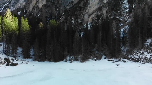 Braies Lake blotted in winter, aerial view from drone, Italian Alps