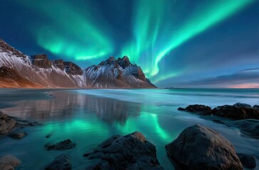 Naklejka premium vestrahorn mountain, black rocks, dark green sky with northern lights