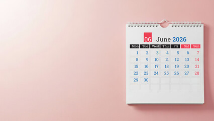 June 2026 wall calendar on pastel pink background with copy space