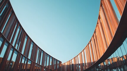 Curved architectural design with a clear blue sky background, modern building.