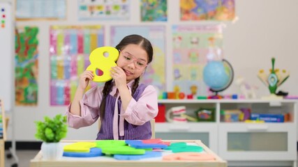 Young Student Holding Foam Number Eight in Classroom Setting - Powered by Adobe
