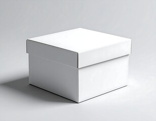 Fototapeta premium Blank white cardboard box with lid, captured at a 45-degree angle on a smooth light grey studio background, perfect for product packaging mockups, branding, and gift presentation design