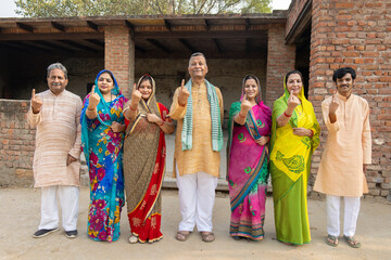 Fototapeta premium Rural indian people wearing showing finger after casting vote. Democracy and election in india.