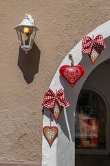Wall lantern and red heart decorations framing an arched doorway